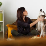 Young woman singing with her dog