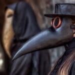 couple-in-love-in-suits-and-masks-of-plague-doctor-during-epidemic-picture-id1217380149