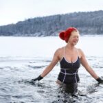 front-view-of-active-senior-woman-in-swimsuit-outdoors-in-water-in-picture-id1300846020