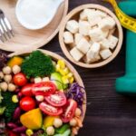fresh-vegetable-salad-and-healthy-food-for-sport-equipment-for-women-picture-id1174616486