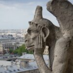 gargoyle-thinking-on-top-of-notre-dame-picture-id1196510190