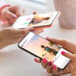 two-women-using-their-mobile-phones-together-picture-id1152544461