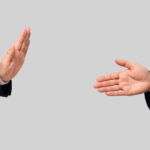 Businessmen facing each other and recommending a handshake and businessmen refusing. Social distance.